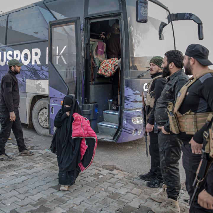 Photo of a girl being transferred from a camp for Islamic-State-affiliated detainees in Syria.