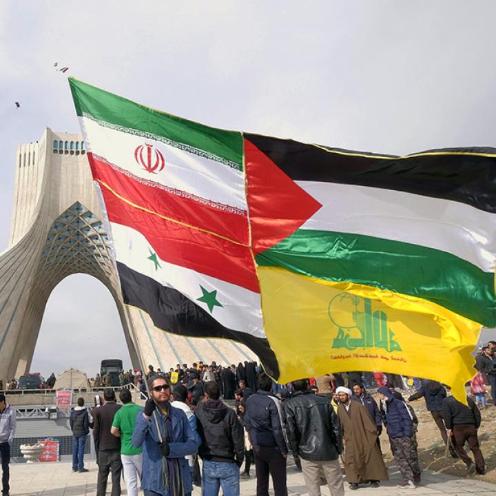 Protesters display Iranian, Syrian, Palestinian, and Hezbollah flags - source: Reuters