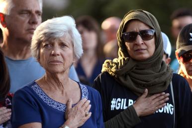 Women with hands on hearts, Gilroy, California, vigil