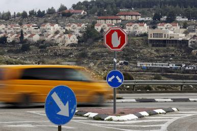 Traffic passes the Israeli settlement of Efrat in the West Bank