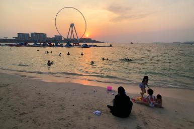 An Emirati family relaxes on the shore in Dubai