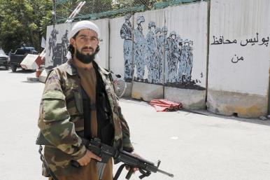 A Taliban fighter at a police station in Kabul