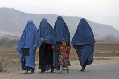 Women and a child walk near Kabul, Afghanistan - source: Reuters