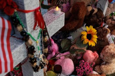 A memorial to victims of the mass shooting at the Allen Premium Outlet mall near Dallas, Texas - source: Reuters