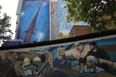 A sign and mural in Tehran promote the Fatteh missile and threaten Israel with the slogan "400 Seconds to Tel Aviv" - source: Reuters