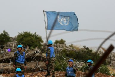 Photo showing an Israeli tank and UN peacekeeping forces on the border with Lebanon.