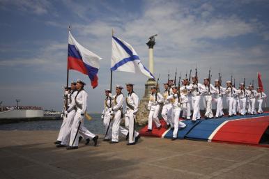 Russian sailors parade with their national and Navy flags in the port of Sevastopol in occupied Crimea - source: Reuters