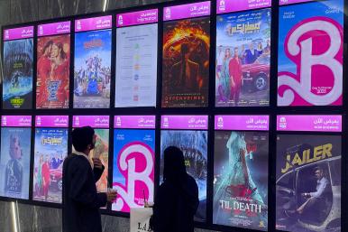 Moviegoers look at posters and showtimes at a theater in Riyadh, Saudi Arabia in August 2023, including the global hit "Barbie" - source: Reuters
