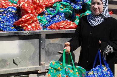 Member of the Ramadi Widows Outreach Assistance Program distributes food packages in Anbar Province