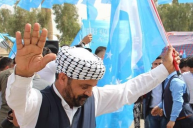 Iraqi Turkmen man with a Turkmen flag