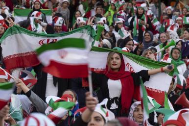 Iranian women display their national flag at a soccer game - source: Reuters