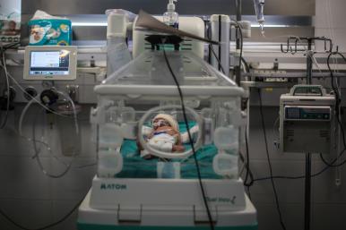 Photo of a Palestinian infant receiving care at a Gaza hospital.