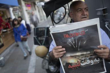 An Iranian man holds a newspaper depicting the April 14 attack on Israel.