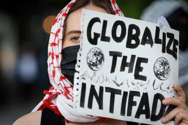 A student protester holds a sign reading "Globalize the Intifada" at Columbia University in New York City - source: Reuters