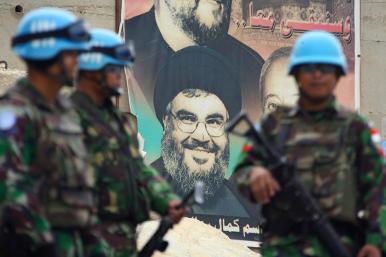 UNIFIL peacekeepers in Lebanon in front of a poster depicting Hezbollah chief Hassan Nasrallah - source: Reuters