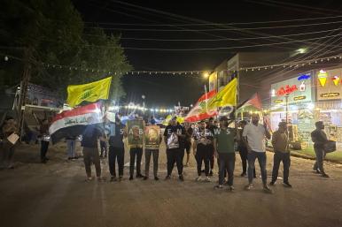 Protestors carrying Iraqi, Lebanon, and KH flags
