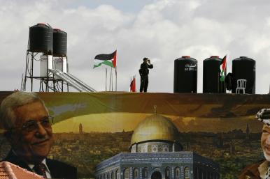 A police officer loyal to the Palestinian Authority stands guard on a wall at PA headquarters in Ramallah in 2007 - source: Reuters
