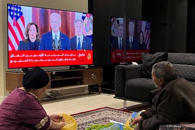 A photo of Palestinians watching President Biden's announcement of the Gaza ceasefire deal, January 2025.
