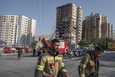 Emergency crews work at the scene of an Israeli air strike in Tehran in June 2025 - source: Reuters