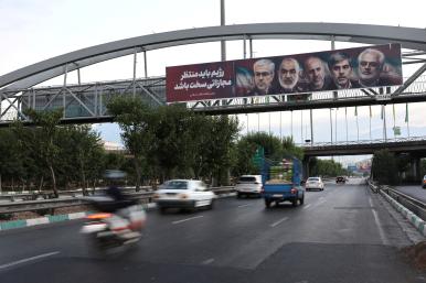 A highway bridge in Tehran displays images of nuclear scientists killed during Israeli strikes against Iran in June 2025 - source: Reuters