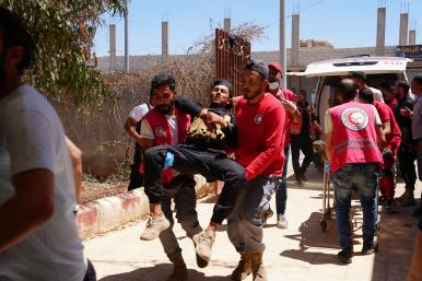 Photo of Syrian medics evacuating injured troops after violent clashes in Suwayda province..