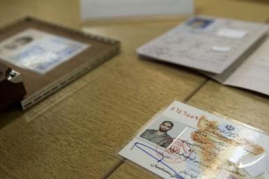 Iranian officials display what they claim to be counterfeit identification documents seized from accused spies - source: Reuters