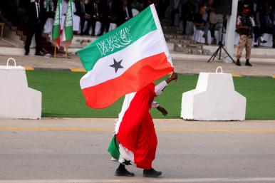 A man carries a Somilaland flag in a parade in Hargeisa - source: Reuters