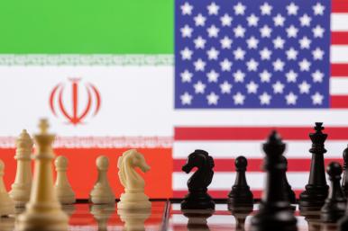A photo illustration depicts chess pieces and the Iranian and U.S. flags - source: Reuters