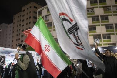 Iraqi protesters display Iranian and Popular Mobilization Forces militia flags at a demonstration in Baghdad following the killing of Iranian Supreme Leader Khamenei - source: Reuters