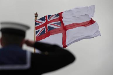 A British sailor salutes the Royal Navy flag - source: Department of Defense