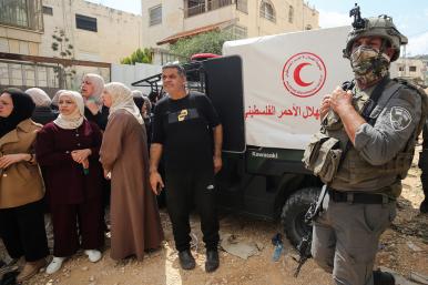Palestinain refugees wait for IDF permission to gather their belongings while benig expelled from a camp near Jenin - source: Reuters