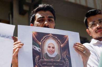 Photo of Syrians holding a memorial protest for family members killed by the former Assad regime.