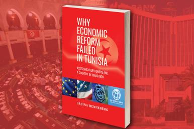 Against parliamentary hall backdrop, book cover includes Tunisian flag imagery at top, EU, USA, IMF, World Bank imagery at bottom. 