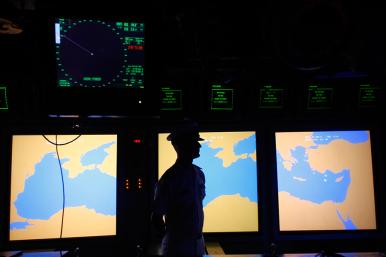 A US Navy sailor stands in front of a map display of the Mediterranean Sea - source: Reuters