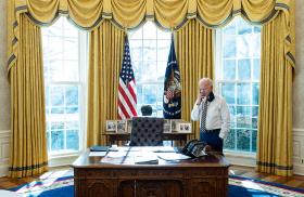 President Joe Biden speaks on the phone in the Oval Office of the White House