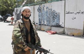 A Taliban fighter at a police station in Kabul