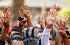 Muslim Brotherhood supporters in Egypt display the victory and Rabaa signs at a protest