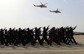 Iraqi forces marching, helicopters overhead