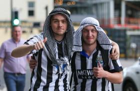Newcastle United fans celebrate the Saudi purchase of their team