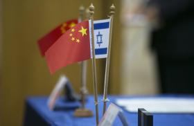 Chinese and Israeli flags on a table at a diplomatic conference - source: Reuters