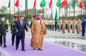 Crown Prince Muhammad and President Xi walking in Riyadh.