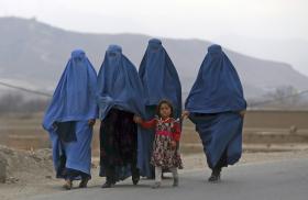 Women and a child walk near Kabul, Afghanistan - source: Reuters