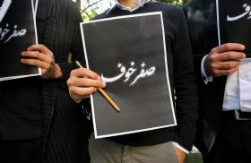 Lebanese protesters hold signs reading "Fearless" in Arabic in response to the assassination of Lokman Slim - source: Reuters