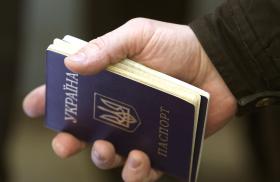 A refugee from the Russian invasion of Ukraine holds a Ukrainian passport - source: Reuters