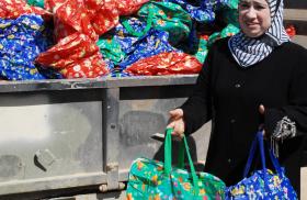 Member of the Ramadi Widows Outreach Assistance Program distributes food packages in Anbar Province