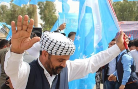 Iraqi Turkmen man with a Turkmen flag