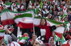 Iranian women display their national flag at a soccer game - source: Reuters