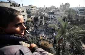 A Palestinian views a building reduced to rubble in Gaza - source: Reuters