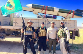 Kataib Al-Imam Ali fighters and an artillery rocket