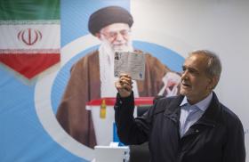 Iranian presidential candidate Masoud Pezeshkian poses in front of a poster of Iranian Supreme Leader Khamenei prior to Iran's 2024 presidential elections - source: Reuters